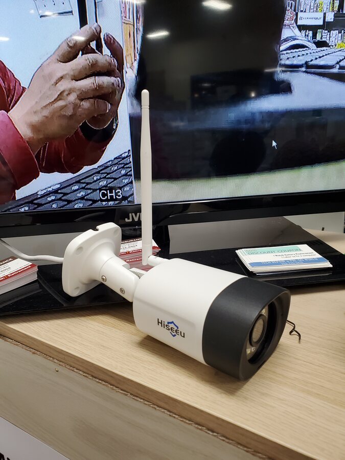 Security camera being prepared for installation